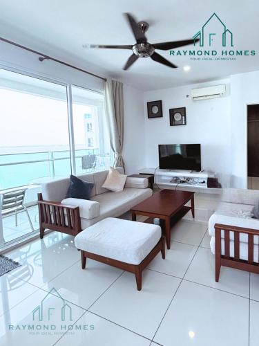a living room with a couch and a tv at Gurney Drive Mansion One Serviced Apartment in George Town