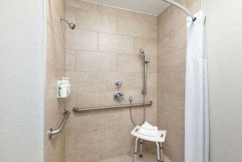 a bathroom with a shower with a toilet at Baymont by Wyndham Nashville Airport in Nashville
