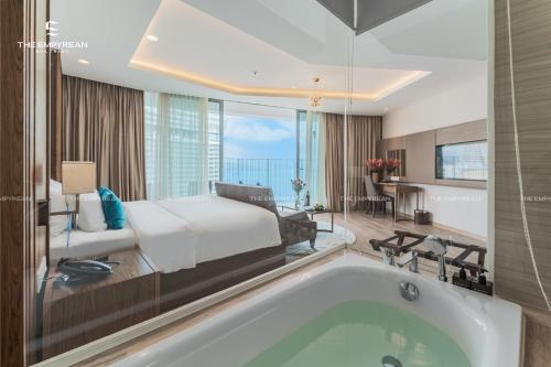 a hotel room with a bed and a tub at The Empyrean Nha Trang in Nha Trang