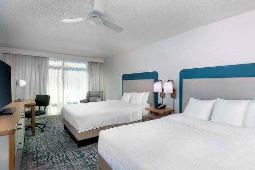 a hotel room with two beds and a desk at Homewood Suites by Hilton Tampa Airport - Westshore in Tampa