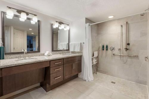 a bathroom with a double sink and a shower at Hilton Vacation Club Aqua Sol Orlando West in Orlando