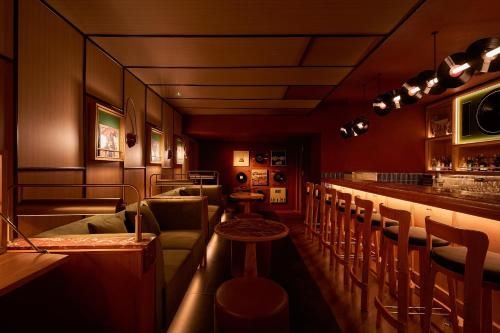 a bar in a restaurant with chairs and a counter at CLASSYC Hotel in Hanoi