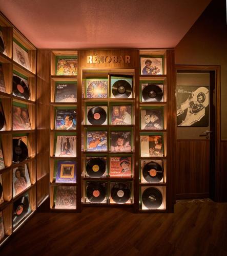 a room with a wall full of records at CLASSYC Hotel in Hanoi