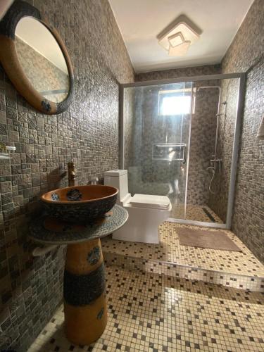 a bathroom with a sink and a shower at TheLight Villa in Trou dʼ Eau Douce