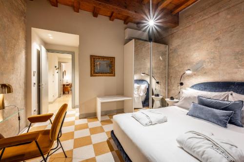 a bedroom with a large white bed in a room at Palazzo Scappi Gardi Luxury Apartments in Bologna