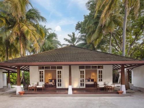 a pavilion with tables and chairs and palm trees at Adaaran Select Meedhupparu - with Dine around Premium All inclusive - 24 hours in Meedhoo