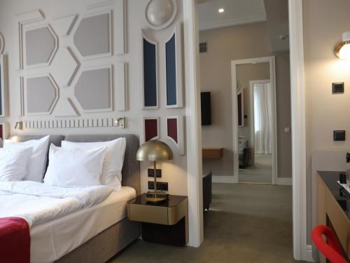 a bedroom with a bed and a table with a lamp at Moselle Armenia Wellness & Medical SPA Jermuk in Jermuk