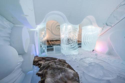 an ice room with a bed in the background at Arctic SnowHotel & Glass Igloos in Sinettä