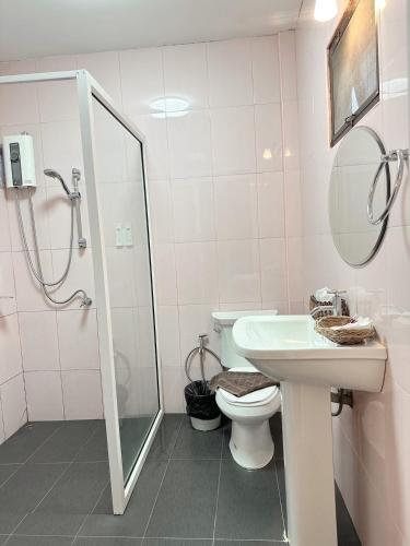 a bathroom with a toilet and a sink and a shower at Baanboonpetch Resort in Ban Phlong Takhe