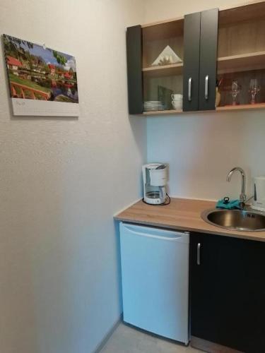 a kitchen with a sink and a counter top at Pension Volgenandt in Breitenbach