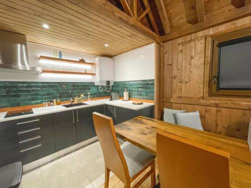 a kitchen with a table and chairs and a television at Mountain Eco Shelter 1 in Funchal