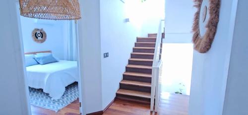 a bedroom with a staircase and a bed and a mirror at Tia Beach House - pool, beach and hamman in Albion
