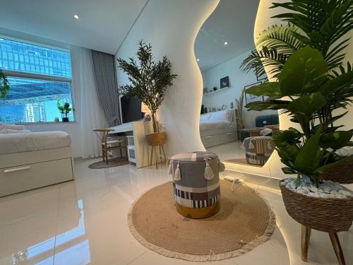 a living room with potted plants and a table at ASHRI HH, Bohemian Style Condo in Downtown in Dubai