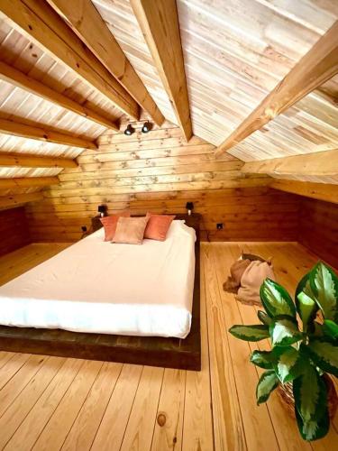 a bedroom with a bed in a wooden room at Mountain Eco Shelter 3 in Corujeira de Dentro