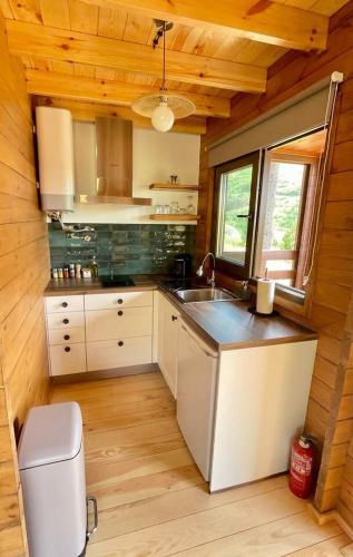 a kitchen with a sink and a counter in a cabin at Mountain Eco Shelter 3 in Corujeira de Dentro