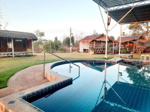 a swimming pool in front of a house at VicaWorld in Prathai