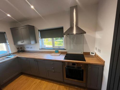 a kitchen with a sink and a stove top oven at Gorgeous 1 bedroom property, close walk to Goodrington beach in Paignton