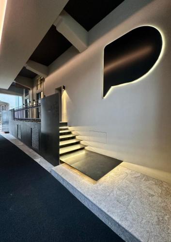 a staircase in a building with lights on the wall at Piranesi 246 in Milan