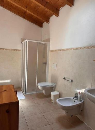 a bathroom with a shower and a toilet and a sink at Secondo Monolocale Ovest in Dolcè