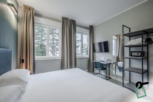 Un ou plusieurs lits dans un hébergement de l'établissement HOTIDAY Apartment Collection - La Spezia