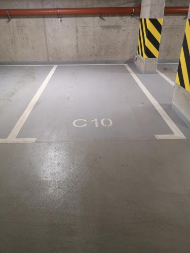 an empty parking lot with the word iso written on the floor at M3 Pruszków in Pruszków
