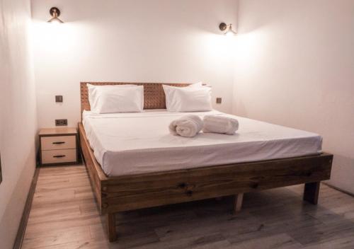 a bedroom with a bed with two towels on it at TheLight Villa in Trou dʼ Eau Douce