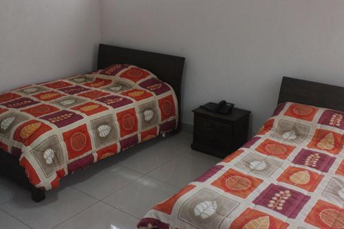 Cama o camas de una habitación en San Agustin Hotel Campestre Las Palmeras