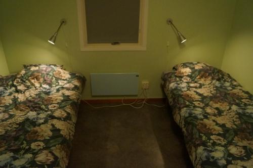 a room with two beds in a room at Laplanders rooms in Kiruna