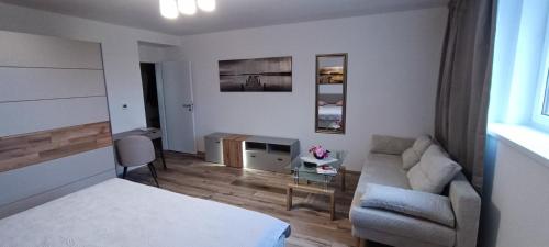 a living room with a bed and a couch at Aparthotel Praha in Prague