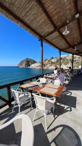 a table and chairs on a boat near the ocean at Apollon Club & Thermal Spa in Ischia