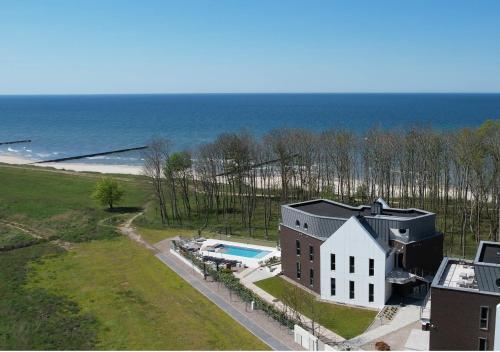 an aerial view of a house and the ocean at CLIFF Trzęsacz - sea view apartments in Trzęsacz