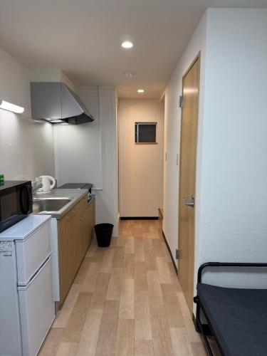 a small kitchen with a sink and a counter at 駐車場有り波除一軒家 in Osaka