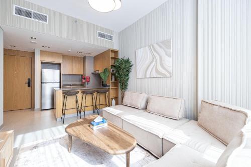 a living room with a couch and a table at Private 1BR Serenity Apartment by Blue Cloud Holidays in Sharjah