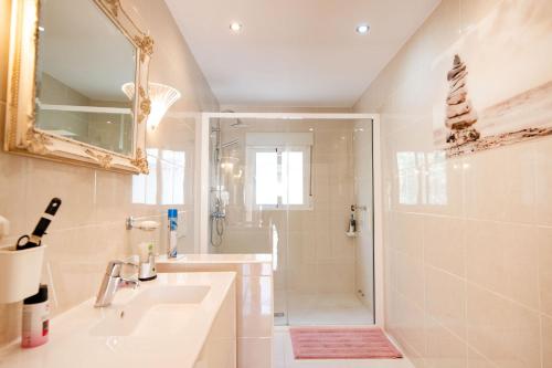 a bathroom with a sink and a shower with a mirror at Sunbathing with private swimming pool in Calpe