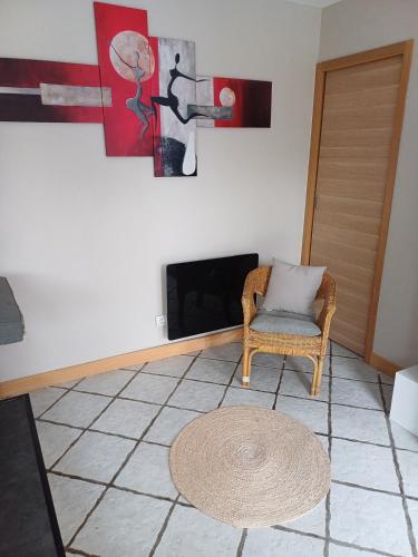 ein Wohnzimmer mit einem Stuhl und einem Kamin in der Unterkunft Studio bord de mer in Port-la-Nouvelle