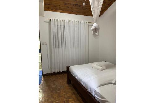 En eller flere senge i et værelse på Bonsai Gardens