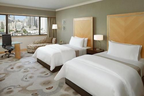 a hotel room with two beds and a window at The Westin Grande Sukhumvit, Bangkok in Bangkok