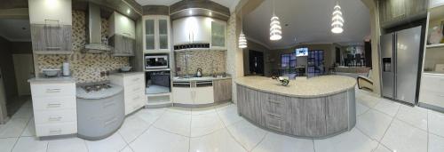 a large kitchen with a large island in the middle at Batuka Damview Lodge in Tshakhuma