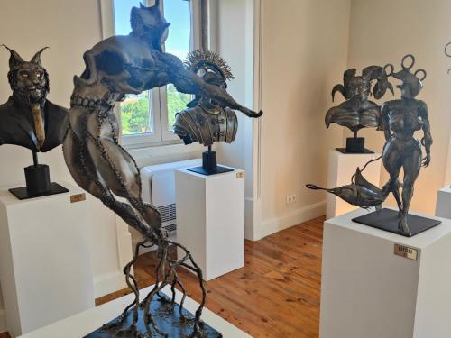 a group of sculptures on display in a room at Pura Vida Alentejo by Portus Alacer in Gavião