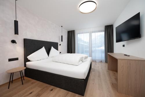 Una cama o camas en una habitación de A CASA Infinity