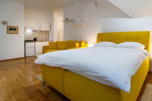 a bedroom with a large bed and a couch at JEZERSKA RESIDENCE Palić in Palić