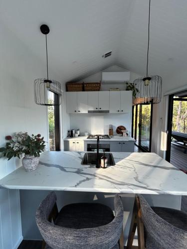 a kitchen with a large white table and chairs at Hilltop Haven Darlington in Darlington