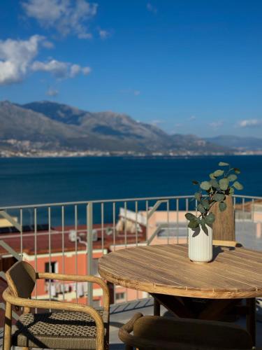 a wooden table with a potted plant on a balcony at Begani63 Boutique Apartments in Gaeta