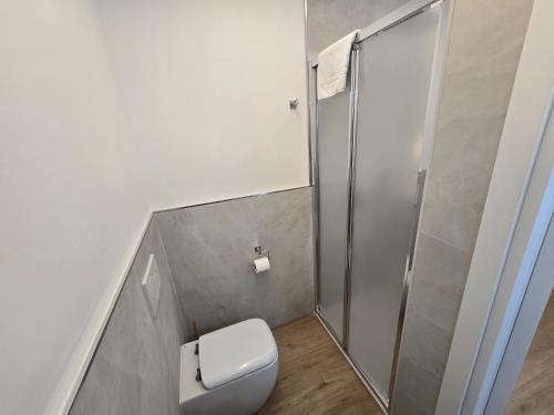 a bathroom with a toilet and a shower at Athena in Alghero