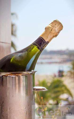 a bottle of wine is on top of a pot at Boutique Hotel B51 in Marbella