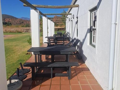 a row of picnic tables on the side of a building at Red Ridge Mountain Lodge in Buffelskloof