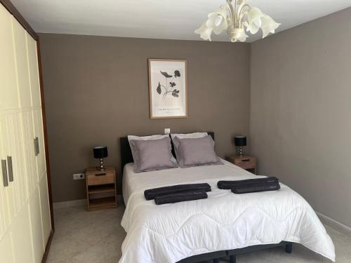 a bedroom with a bed with two towels on it at Sunbathing with private swimming pool in Calpe
