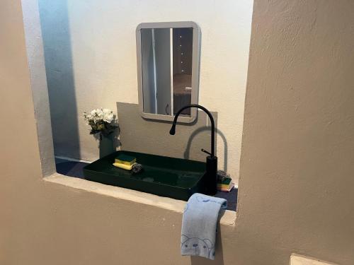 a bathroom with a green sink and a mirror at Jungle Retreat Apartment in Chaloklum