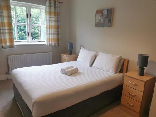 a bedroom with a bed with two towels on it at Bunratty Holiday Homes in Bunratty