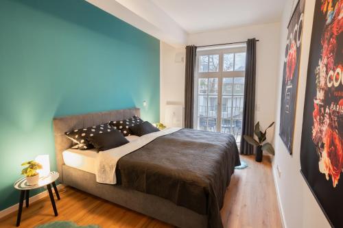 a bedroom with a large bed and a window at ANER 4 Design Apartment Zoe in Dresden